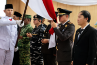 ‎Kejari Bitung Erwin Widihantono, S.H., M.H., Saat mencium Sang saka Merah Putih. (Dok. Istimewa).
